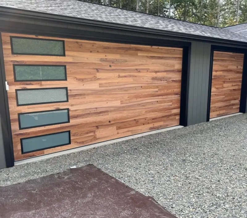 A wood-look garage door with a column of frosted windows.