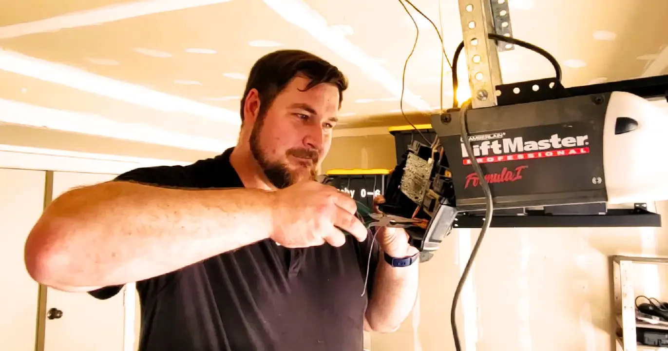 Peter working on a LiftMaster opener mounted on a garage ceiling.